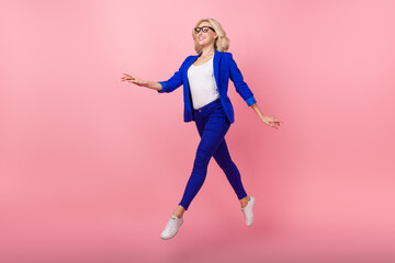 Full size profile photo of cheerful lovely person jump run empty space isolated on pink color background