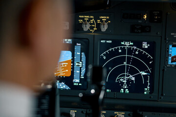 Close-up of an airplane cockpit Center panel with main flight display and navigation display Airplane pilot panels