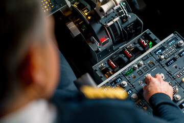 The captain presses the buttons on the control panel to start the engine of the plane flight Up...