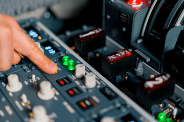 The captain presses the buttons on the control panel to start the engine of the plane flight Up...