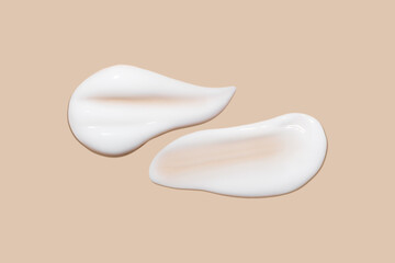 a set of strokes of white cream on a beige background.