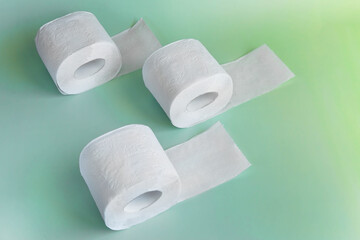 Soft toilet paper rolls on green background