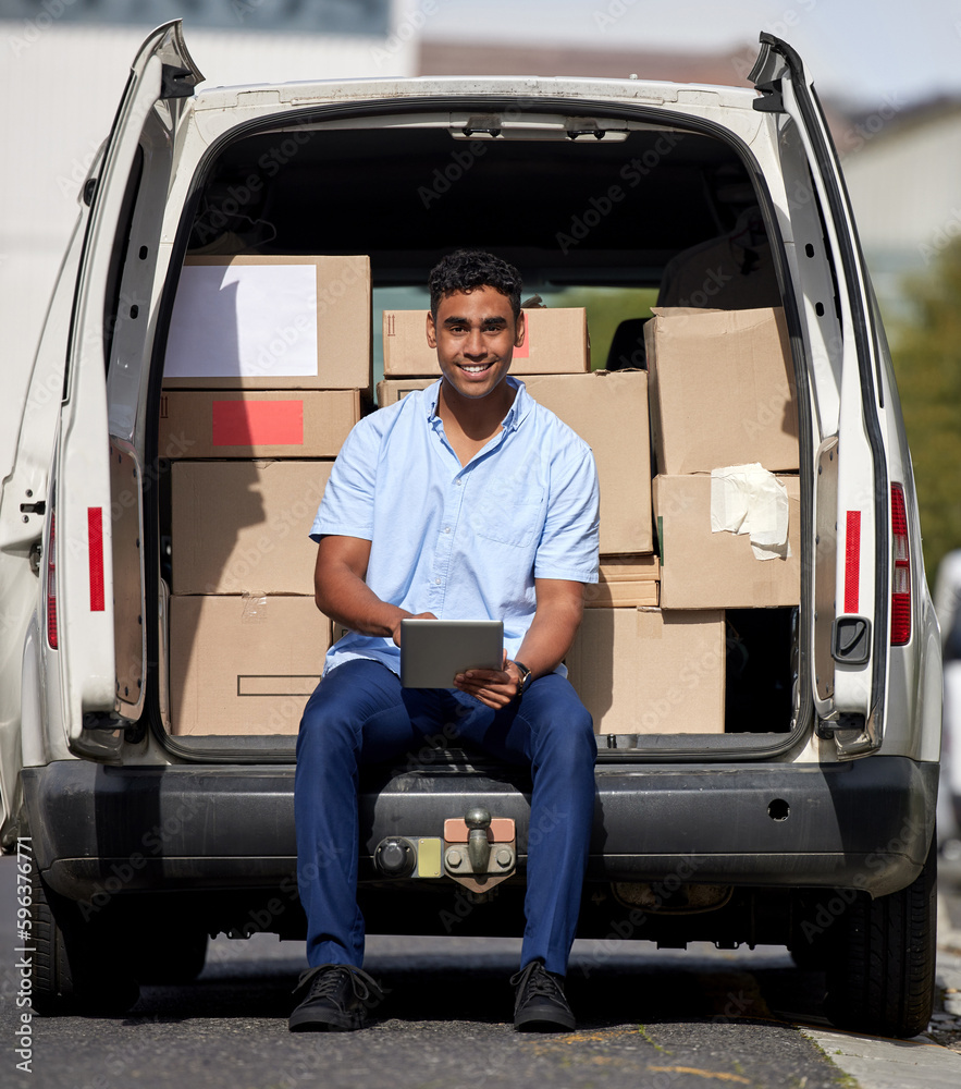 Poster No package goes missing with our tracking system. Portrait of a young delivery man using a digital tablet while loading boxes from a van.