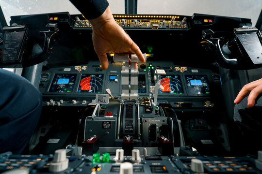 An airplane pilot controls the throttle during flight or takeoff View from inside the cabin