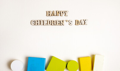 template with inscription happy children's day and colorful wooden construction blocks,pyramid for kids baby toddler.infant toys isolated,letter from wood.celebrate june 1st holiday