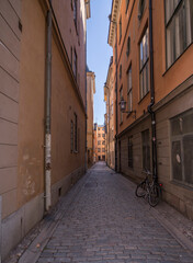 Alley view in the old town Gamla Stan facades and cobblestone street, a sunny spring day in Stockholm