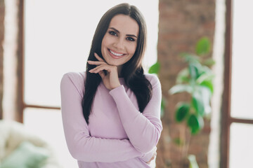 Photo of dreamy adorable charming young girl wear pink shirt smiling arm chin indoors home room