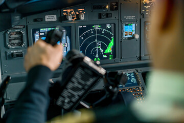 Pilot in airplane cockpit holding turning wheel rudder during flight Aviation travel concept
