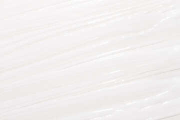 A creamy cosmetic background with smeared cream white. Cream texture full screen