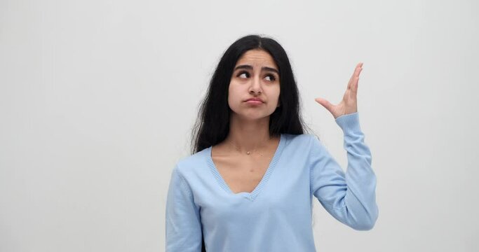 Young woman making blah blah gesture with hand