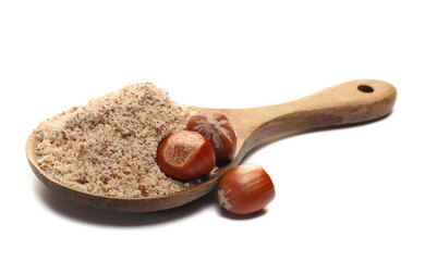Hazelnuts ground pile and whole in shell, wooden spoon isolated on white, side view