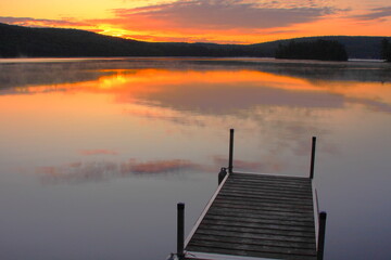 Fototapeta na wymiar Sunrise on lake with dock