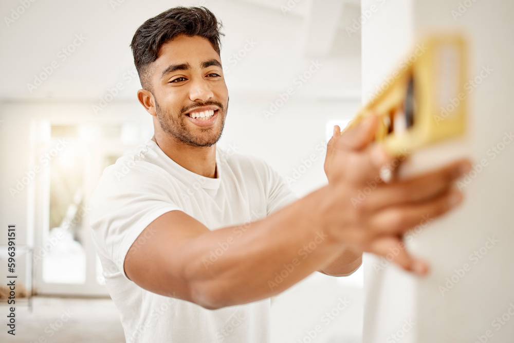 Poster i prefer doing the work myself. shot of a handsome young man standing alone in his home and using a 