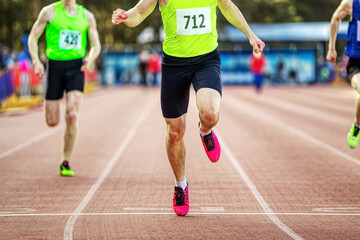 male athlete runner crosses finish line sprint race in athletics championships, close-up man sprinter winner of competition