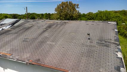 Roof missing shingles from weather and storm damage
