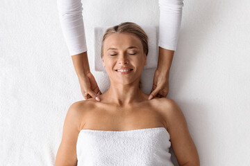 Beauty Treatments. Masseur Making Relaxing Massage To Middle Aged Woman In Spa