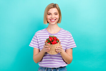 Photo of young smiling girl blonde hair healthy lifestyle dieting eat basket fresh dessert strawberries isolated on cyan color background