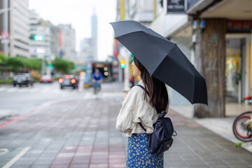 Woman hold with black umbrella at outdoor