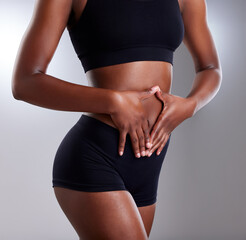 Do whats best for your gut. Studio shot of an unrecognisable woman framing her stomach against a grey background.