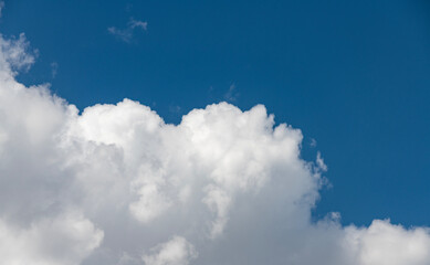 Beautiful huge fluffy clouds on the blue sky. Sky clouds background.
