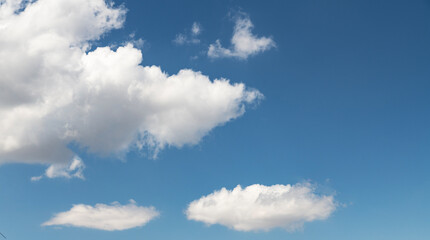 Beautiful huge fluffy clouds on the blue sky. Sky clouds background.