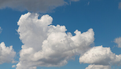 Beautiful huge fluffy clouds on the blue sky. Sky clouds background.
