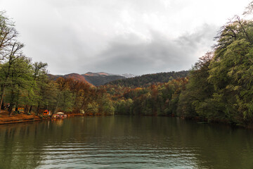 Beautiful autumn landscape with lake and trees at the sunset. 