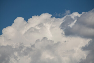 Beautiful huge fluffy clouds on the blue sky. Sky clouds background.