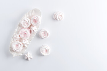 Meringue. Light dessert of whipped egg whites on a white background. copy space