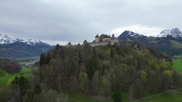 Famous Gruyere Castle in Switzerland also called Schloss Greyerz - aerial view by drone