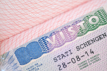 close-up part of page of document, foreign passport for travel with European visa, tourist schengen visa stamp with hologram with shallow depth of field, passport control at border, travel in Europe