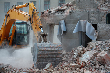 Demolition of building. Excavator breaks old house. Freeing up space for construction of new...