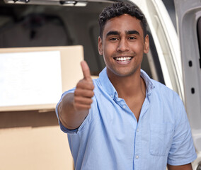 All good to go. Portrait of a young delivery man showing thumbs up while loading boxes from a van.