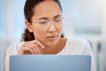 Does anyone actually check this. Shot of a beautiful young businesswoman working on her laptop.