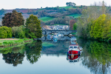 Boats on the River Dart in Totnes reflecting in the still water