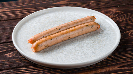 Sausages with spices as an ingredient for breakfast on a plate.