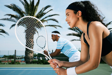 We got this. Shot of an attractive young woman standing and playing tennis with her teammate.