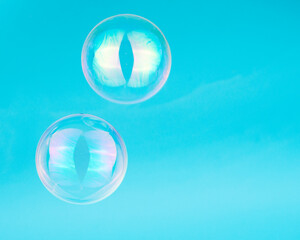Soap bubbles on blue background blured selective