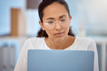 Sights set, mission in place. Shot of a beautiful young businesswoman working on her laptop.