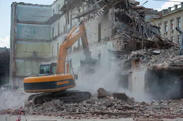 Demolition of building. Excavator breaks old house. Freeing up space for construction of new...