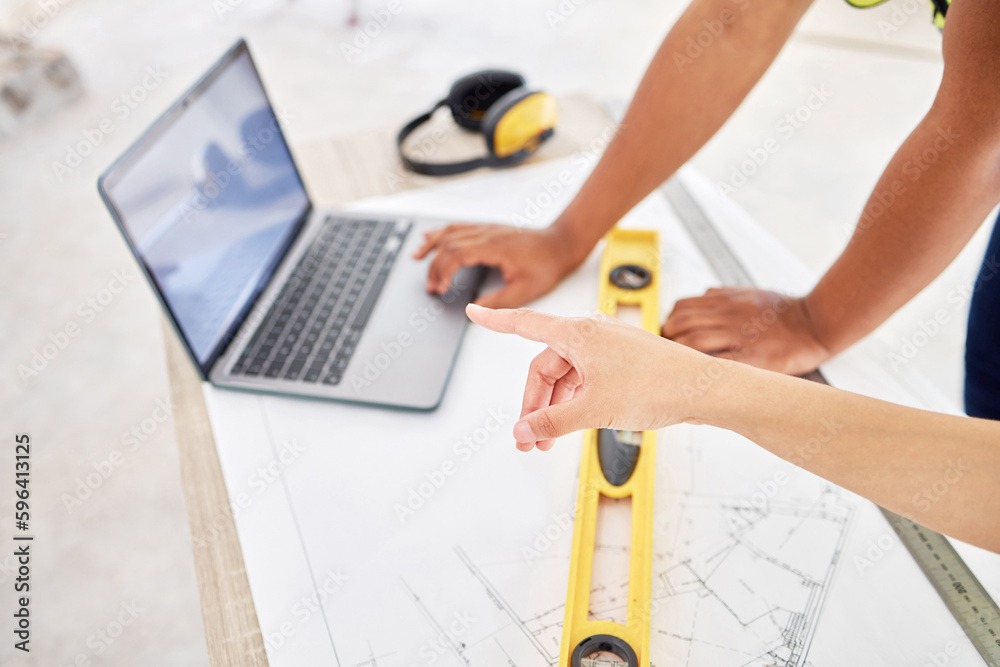 Poster Lets work with that first. Cropped shot of two unrecognisable contractors standing inside together and using a laptop while planning.