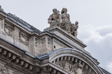 Fototapeta na wymiar Architectural fragment of Brussels Stock Exchange building (BeursBourse) on the Place de la Bourse. The building erected from 1868 to 1873 in the Neo-Renaissance style. Brussels, Belgium.