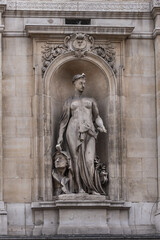 Fototapeta premium Architectural fragment of Brussels Stock Exchange building (BeursBourse) on the Place de la Bourse. The building erected from 1868 to 1873 in the Neo-Renaissance style. Brussels, Belgium.