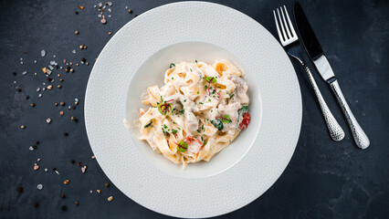 Pasta with mushrooms, tomatoes, basil and cream sauce.