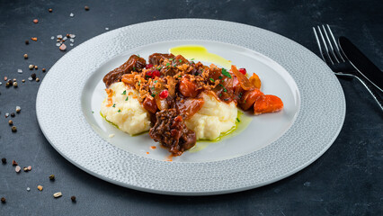 Lunch beef goulash with carrots, tomatoes, onions with mashed potatoes.