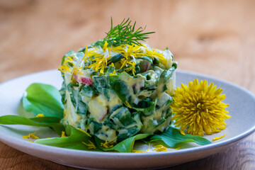 Healthy salad of green wild leek, poached egg and sour cream. Wild garlic salad with boiled eggs