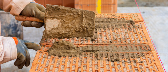 bricklayer at work at new house in construction