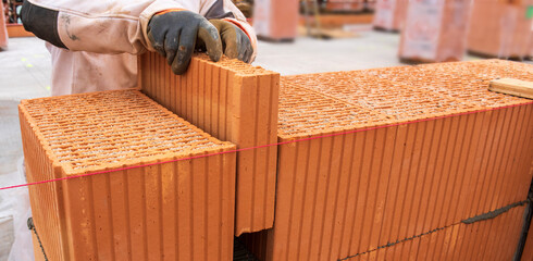 bricklayer at work at new house in construction