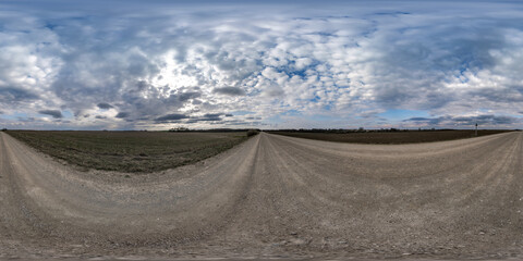 gravel road with clouds on overcast sky as spherical 360 hdri panorama in equirectangular seamless projection, use as sky replacement in drone panoramas, game development as sky dome or VR content