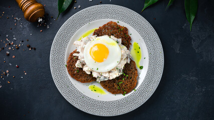 Potato pancakes with eggs and a salad of chicken, mushrooms, onions and sour cream.